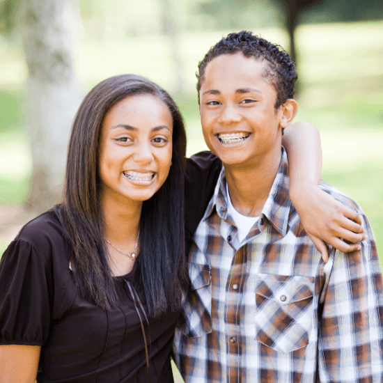 Two teens with traditional metal braces