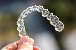 Closeup of Invisalign aligner on a colorful background